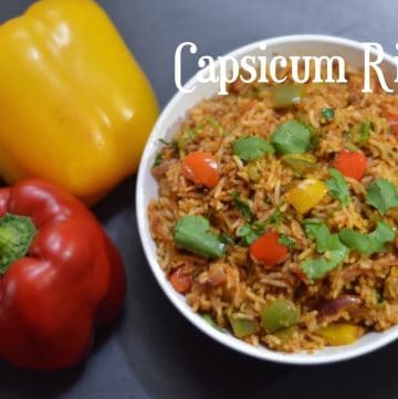 Capsicum Rice served in a bowl garnished with cilantro with colored bell peppers on the side