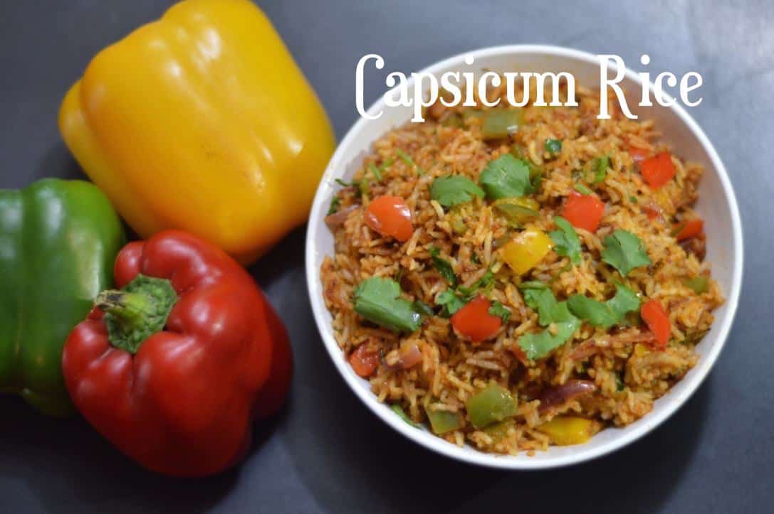 Capsicum Rice served in a bowl garnished with cilantro with colored bell peppers on the side