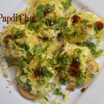 Dahi Papdi Chaat Recipe made using Sweet Potato as filling served on a plate garnished with sev and cilantro