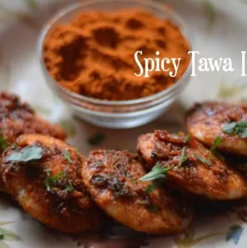 Spicy Tawa Idli served on a plate with idli podi on the side