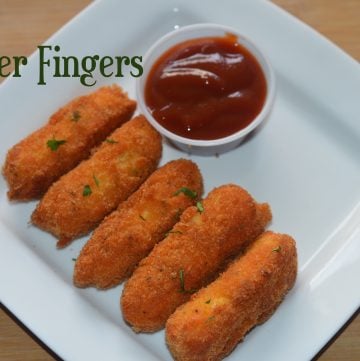 Crispy Paneer Fingers served on a plate with tomato ketchup on the side