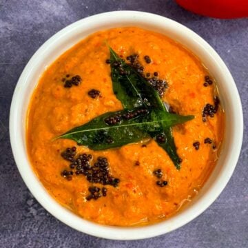 Red Bell Pepper Peanut Chutney served in a bowl with tempering on top