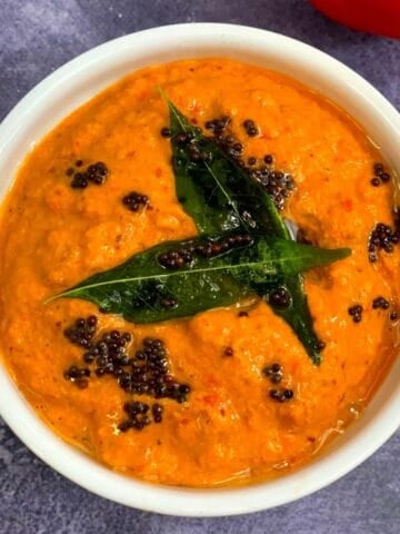 Red Bell Pepper Peanut Chutney served in a bowl with tempering on top