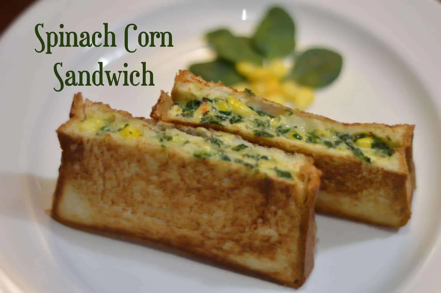 spinach corn sandwich cut into rectangle shape served in a plate