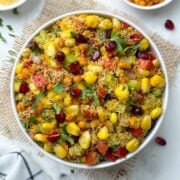 sweet corn bhel/corn chaat served in a bowl garnished with cilantro and pomegranate with boondi and sev on the side