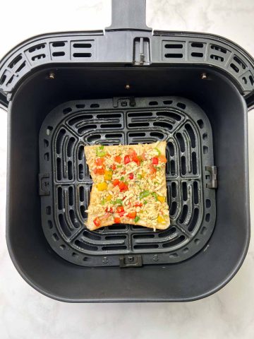 chili cheese toast bread slice on the air fryer basket