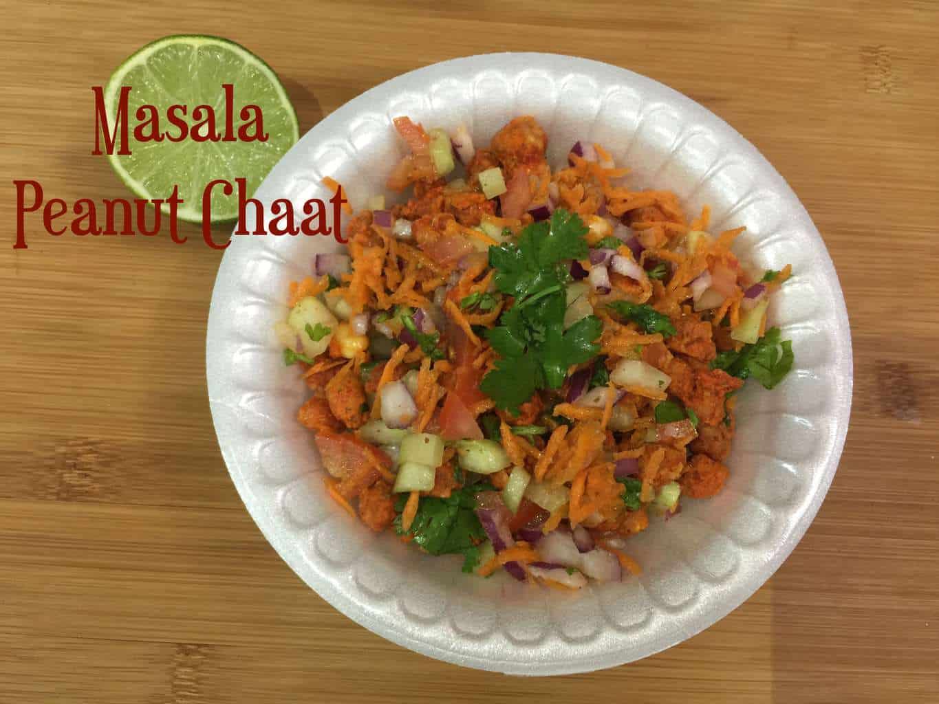 Masala Peanuts Chaat served in a plastic bowl topped with cilantro and lemon on the side