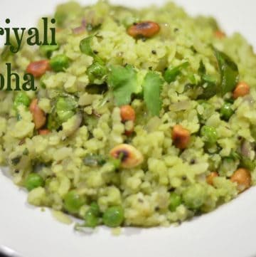 Hariyali Poha | Poha in Green Masala served on a white plate garnished with coriander leaves