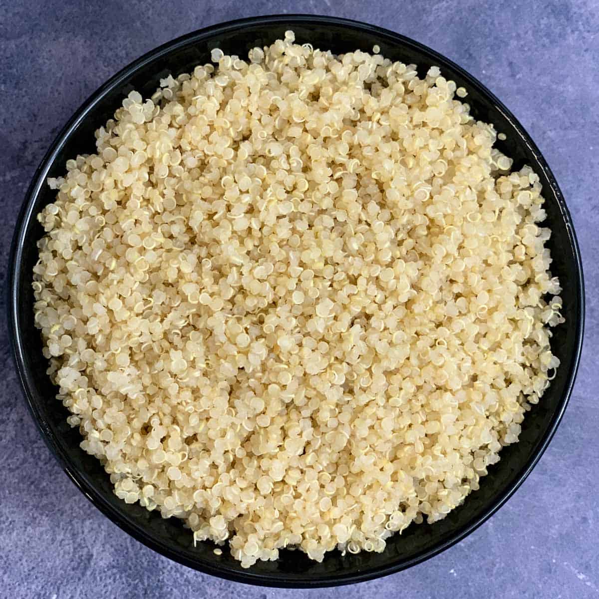 Instant Pot cooked quinoa served in a black bowl