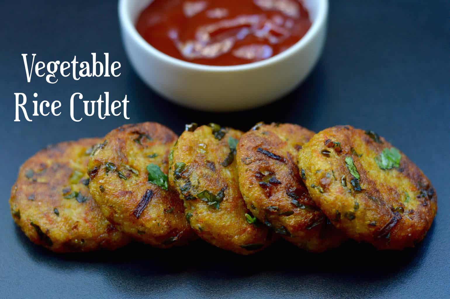 Vegetable Rice Cutlet served on a plate with tomato ketchup on the side