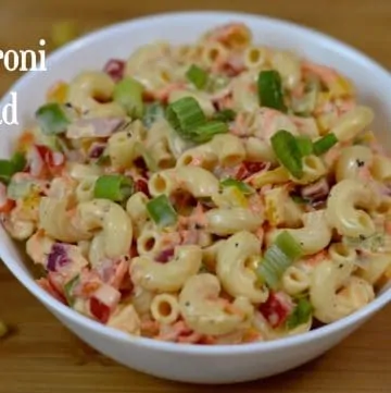 Macaroni Salad served in a bowl garnished with green onions