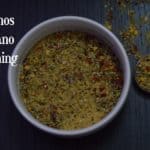 Oregano Seasoning served in a bowl with spoon full of spices on the side