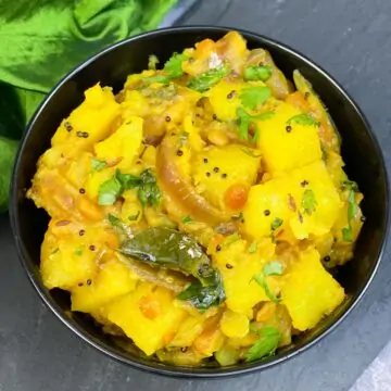 potato masala served in a bowl garnished with cilantro
