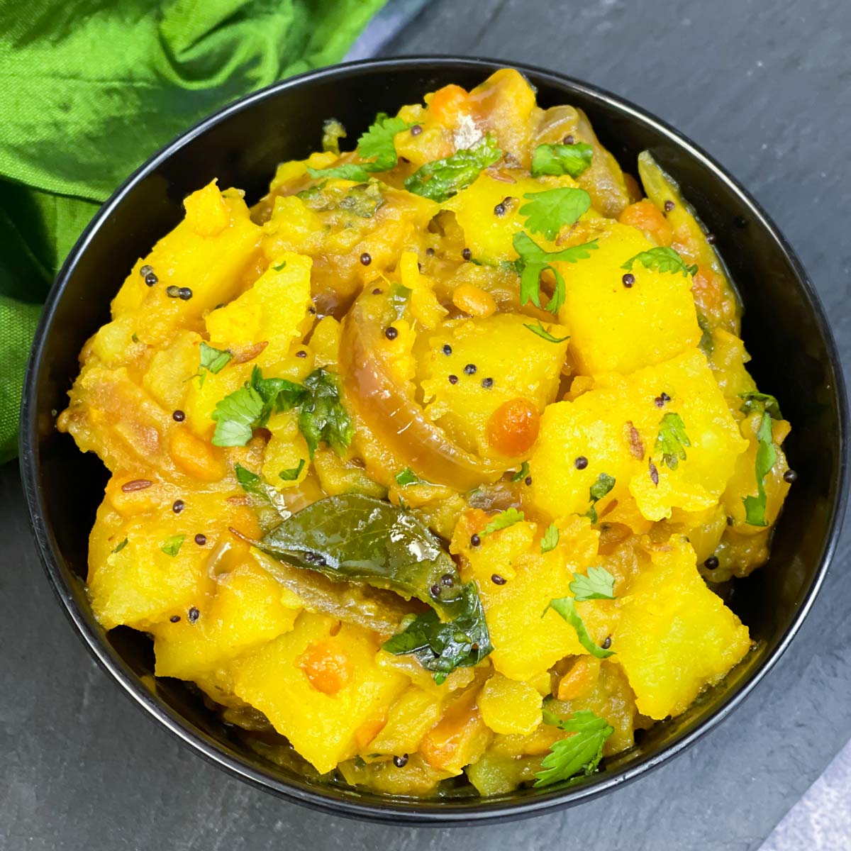 potato masala served in a bowl garnished with cilantro