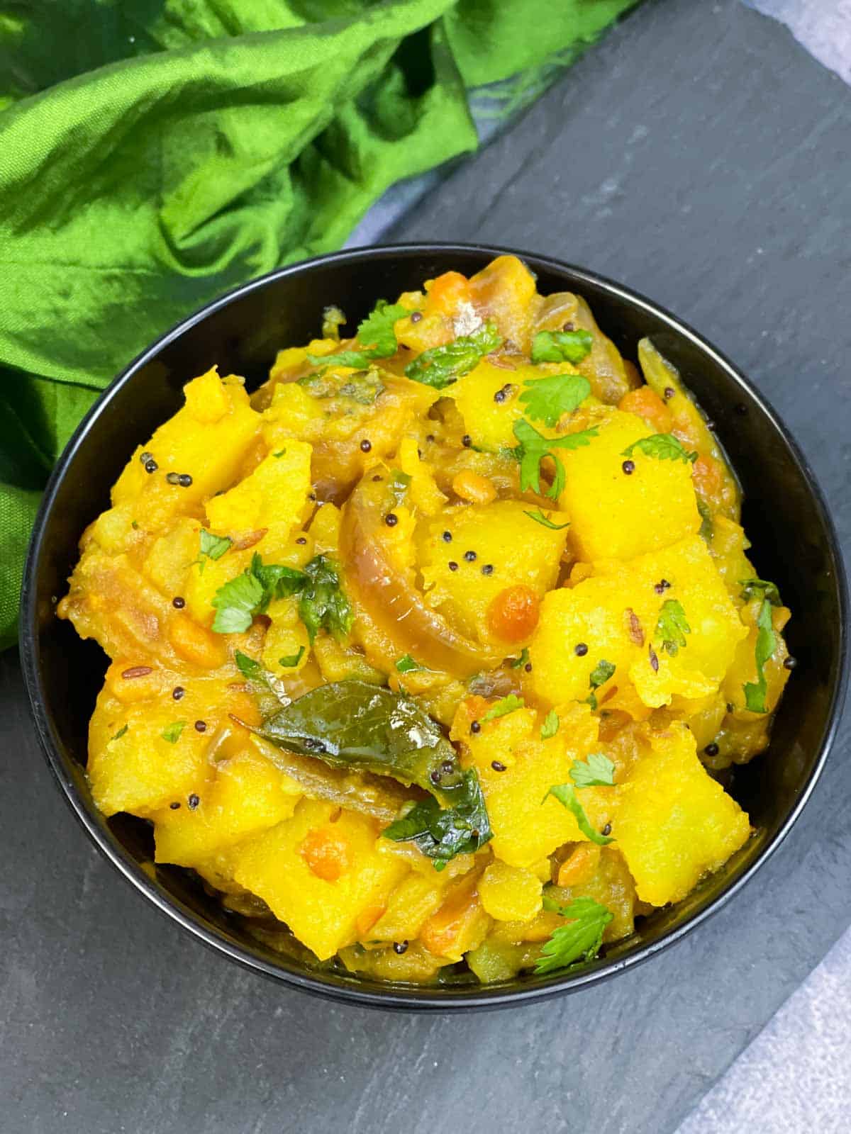 Potato Masala (aloo masala) recipe served in a bowl garnished with coriander leaves