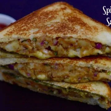 Spicy Potato Sandwich cut into half stacked on one another with tomato ketchup on the side
