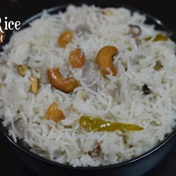 Instant Pot Ghee Rice served in a bowl garnished with cashews