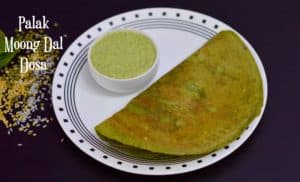palak moong dal dosa served on a plate with coconut chutney on the side