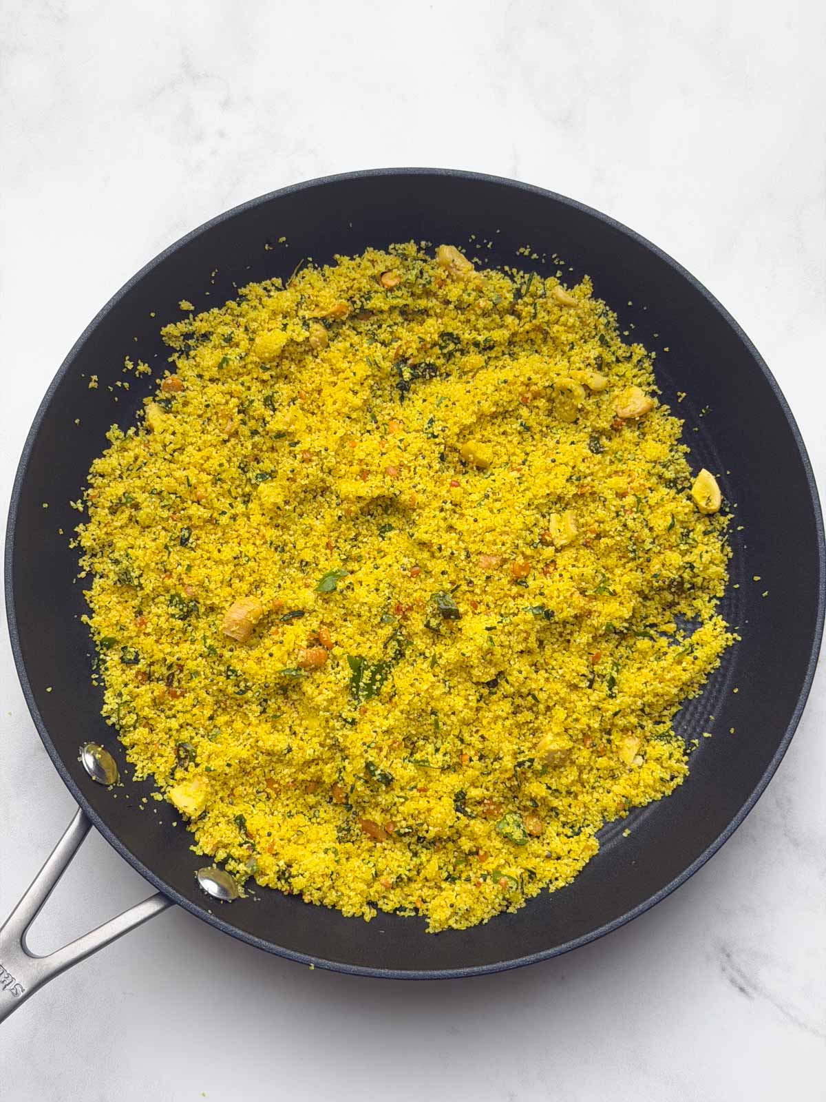 Instant rava upma mix on a black pan.