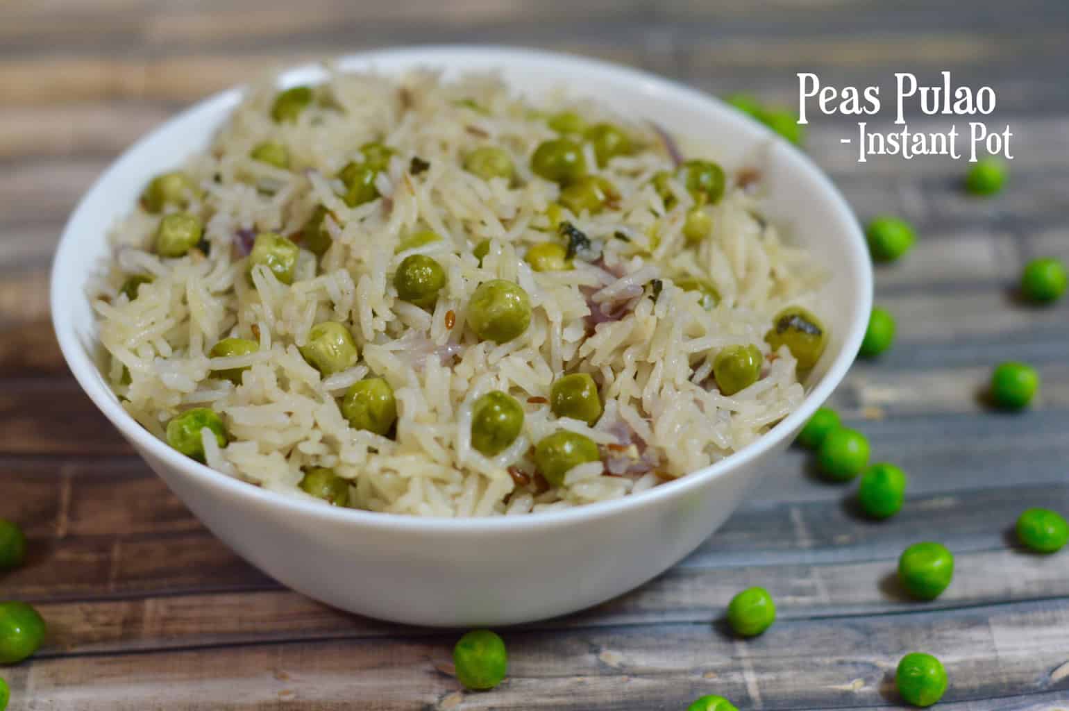 Instant Pot Peas Pulao served in a white bowl with few green peas fallen on the sheet