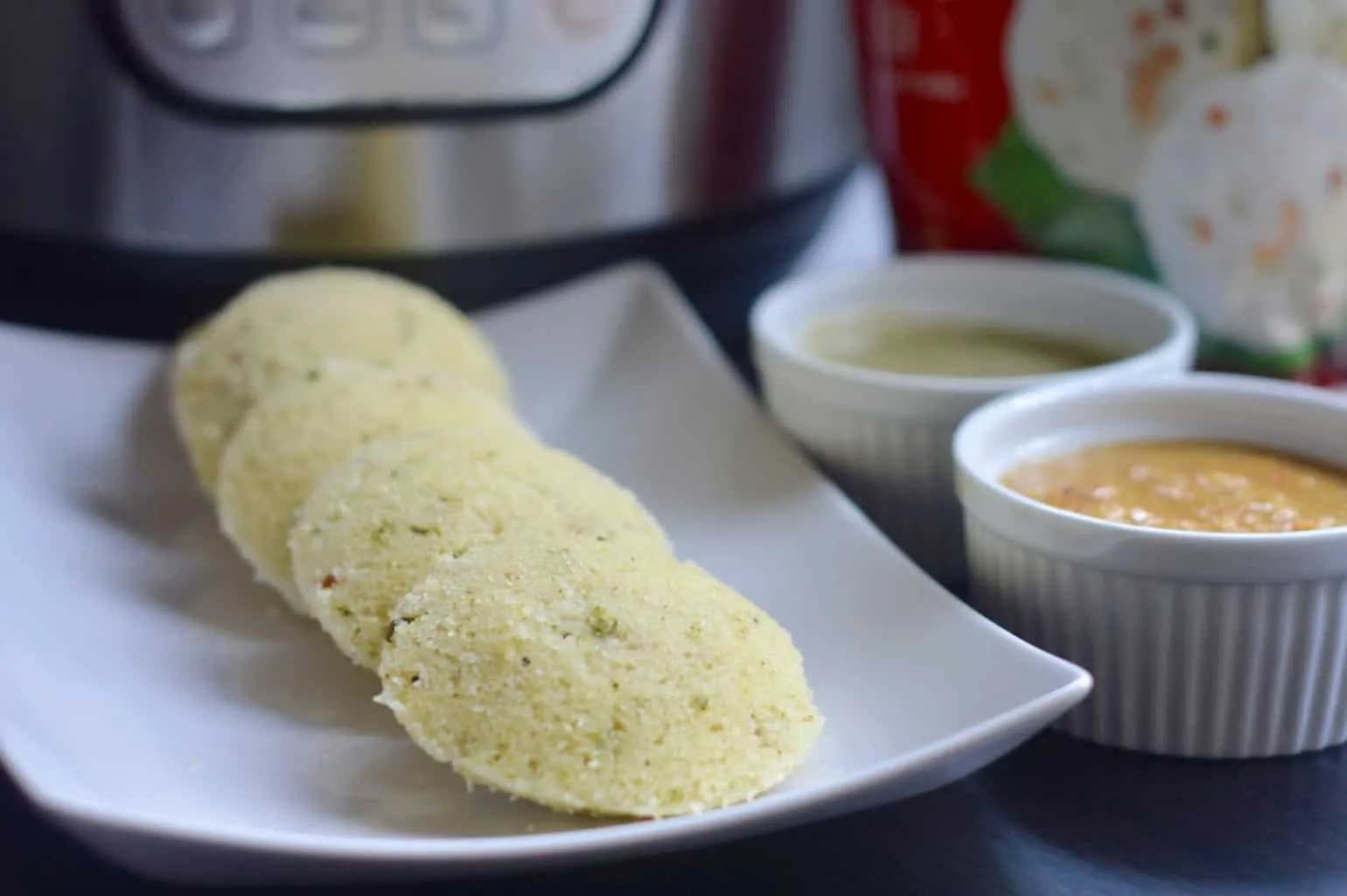 Soft and fluffy Idli or savory rice cakes steamed in an Instant Pot.