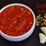 Red Chilli Karindi served in a bowl with garlic and methi seeds on the side