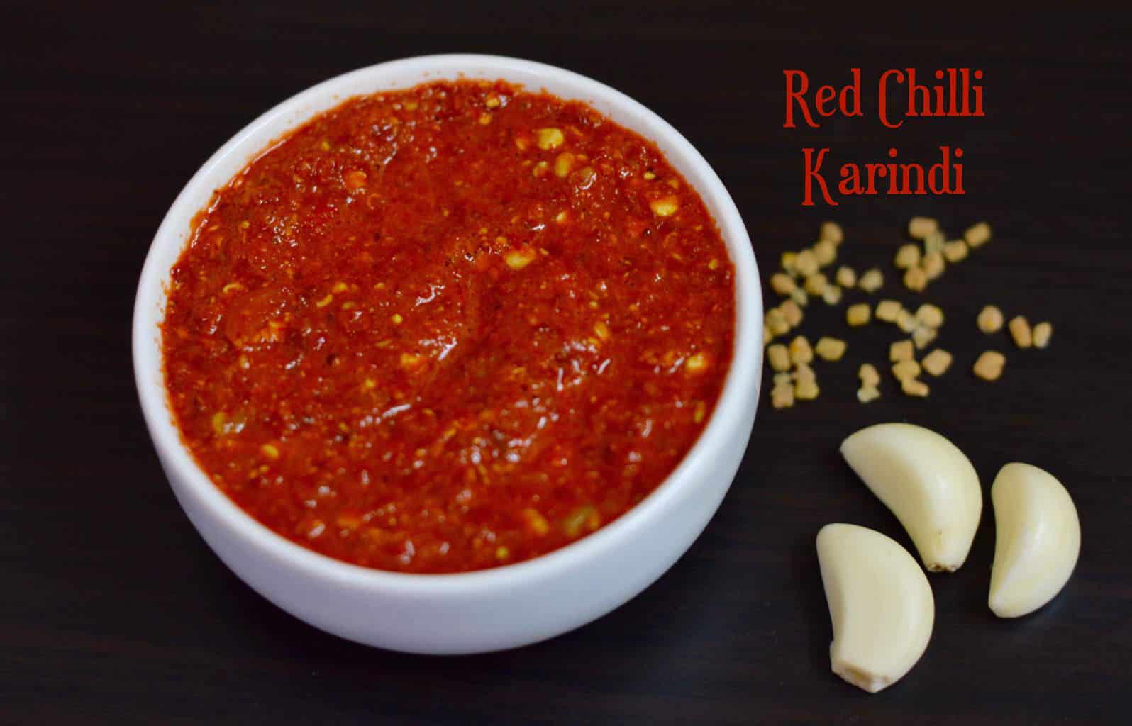 Red Chilli Karindi served in a bowl with garlic and methi seeds on the side