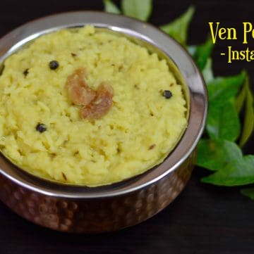 ven pongal cooked in instant pot served in a kadai with cashews on top and curry leaves on the side