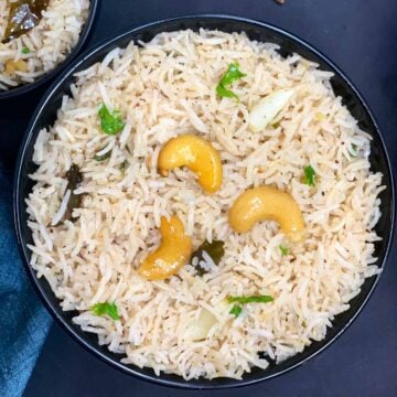 Biranji Anna served in a bowl garnished with cashews and cilantro