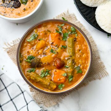 instant pot vegetable sambar served in a bowl with peanut chutney and idli on the side