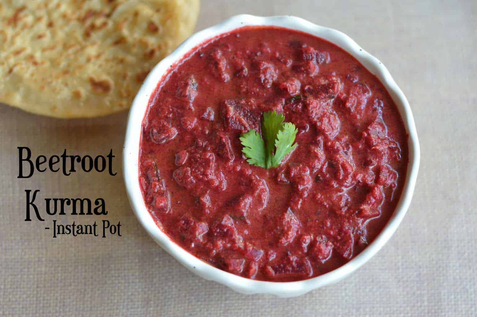 Beetroot Kurma served in a bowl with paratha on the side