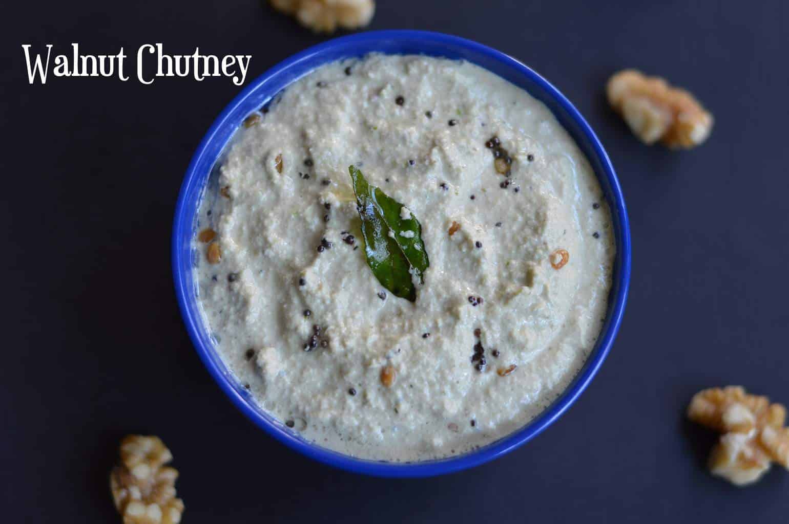 Walnut Chutney served in a bowl with raw walnuts on the side