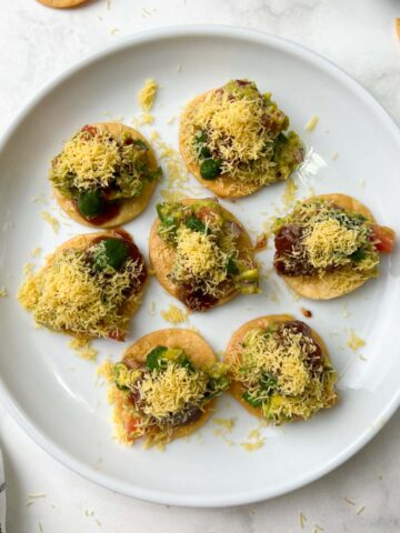 avocado papdi chaat served on a serving plate with chutneys on the side