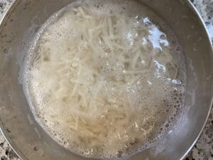 step to add shredded potato in water