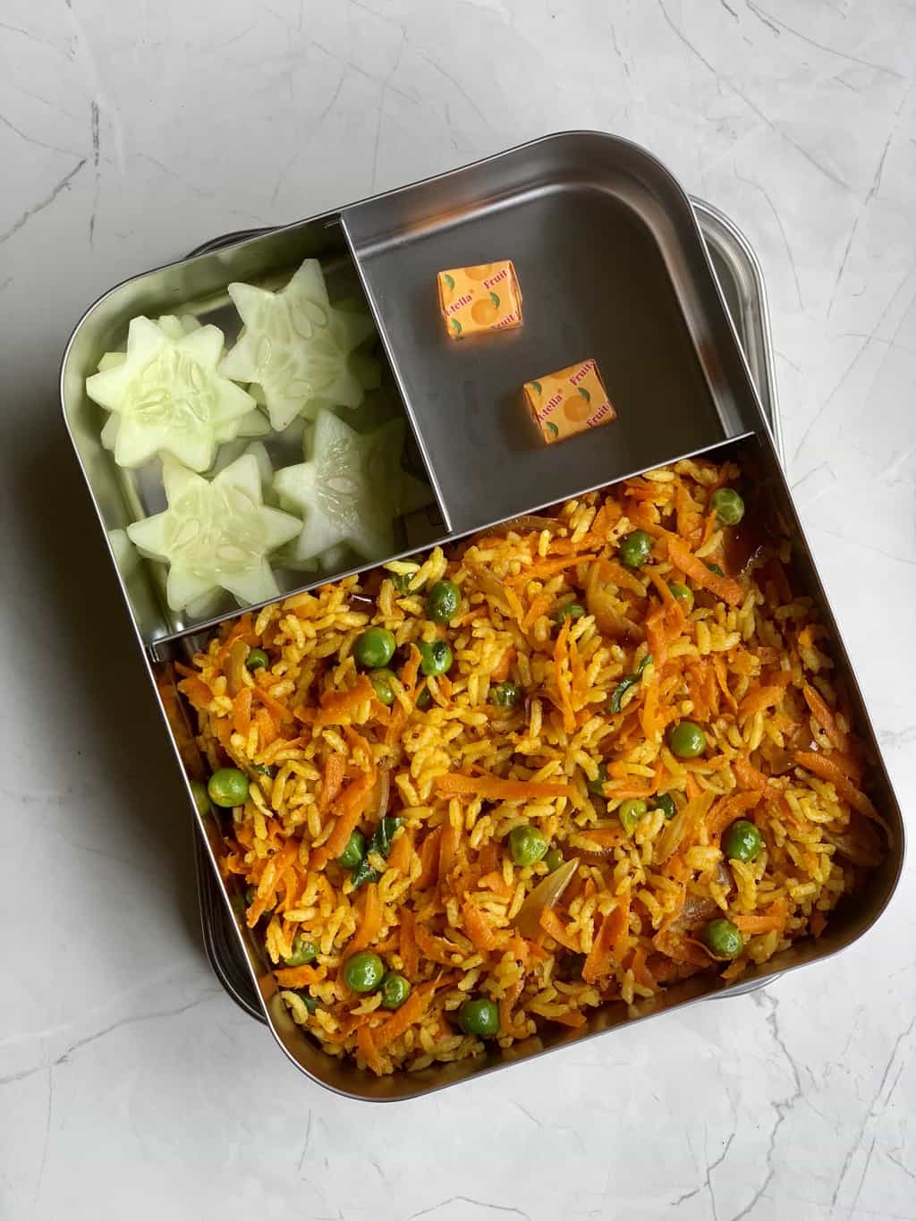 carrot peas rice, candy and star shaped cucumber in steel bento box