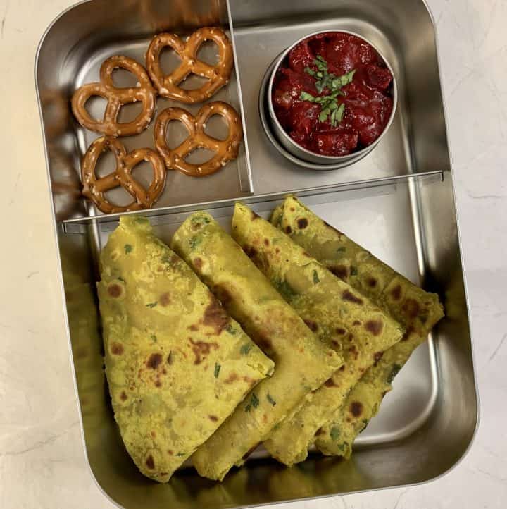 avocado paratha in kids lunch box with pretzels and beetroot curry
