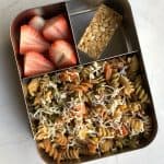 cheesy mayonnaise pasta with chikki and strawberries in bento steel box