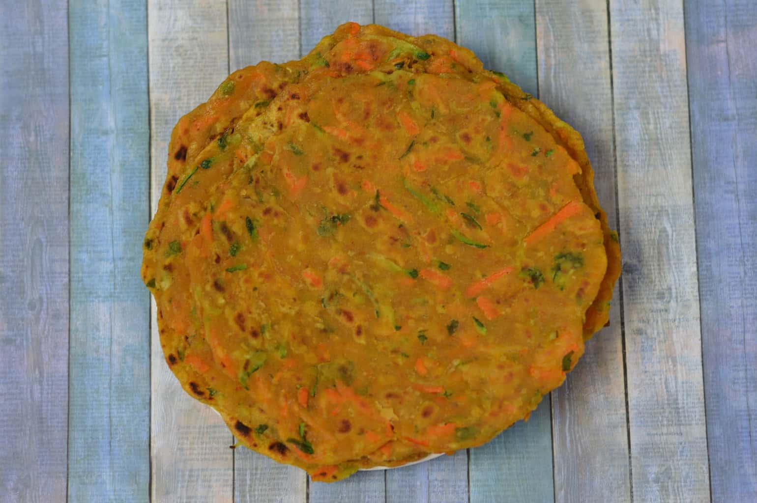 Zucchini Carrot Paratha is a simple and nutritious Indian flat bread that is made from grated zucchini ,carrots ,few spices and whole wheat flour
