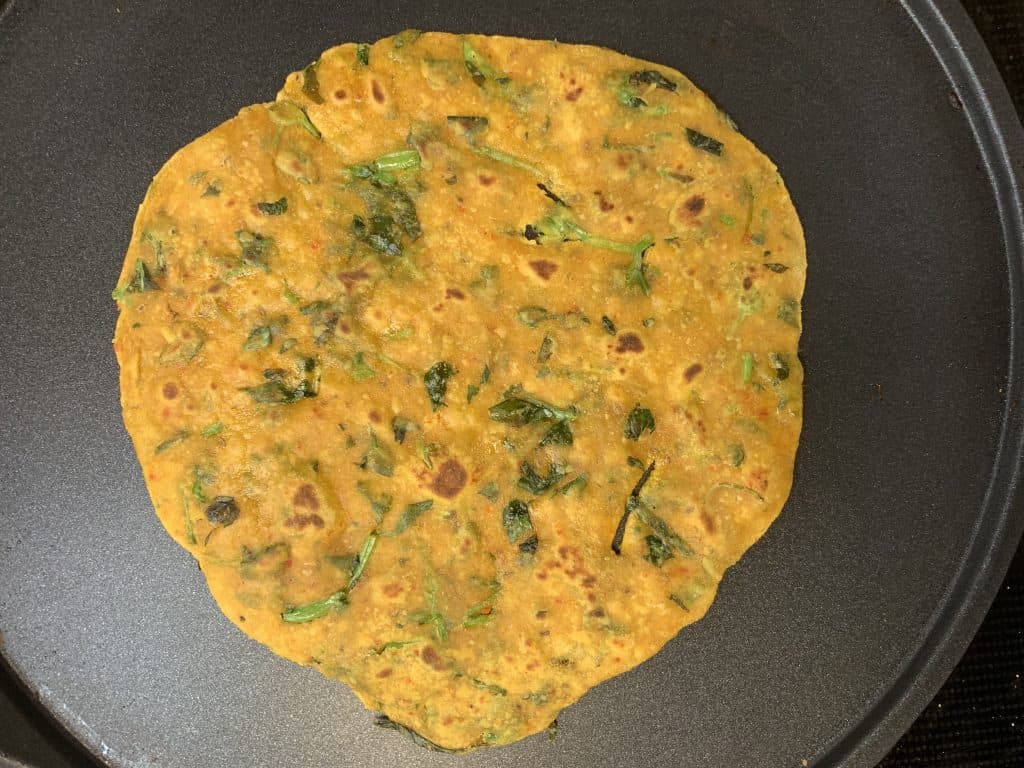 Cooked methi paratha on the tawa