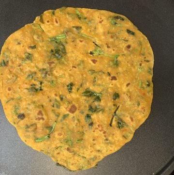 Cooked methi paratha on the tawa