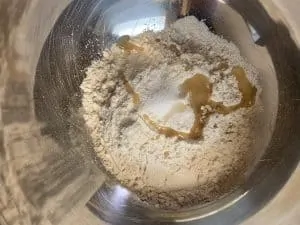 wheat flour and oil in a steel wide bowl
