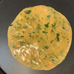 rolled bread on the tawa for cooking