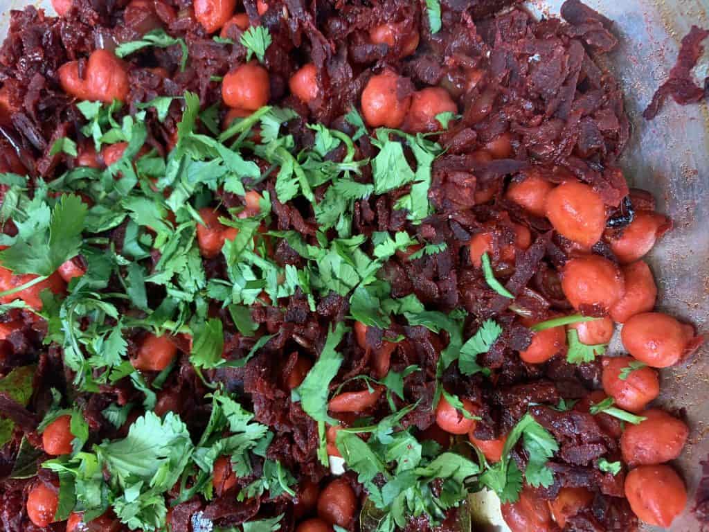 beetroot chickpea stir fry garnished with cilantro in a pan