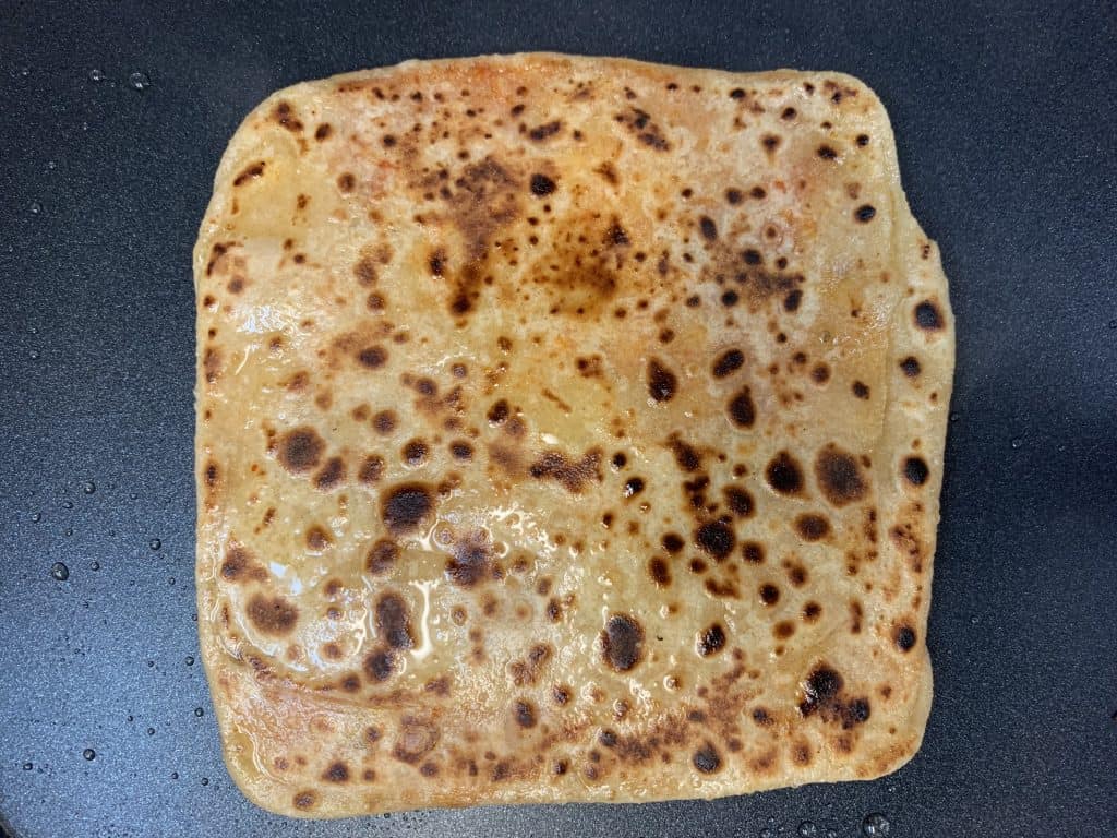 fully cooked ajwain paratha on tawa