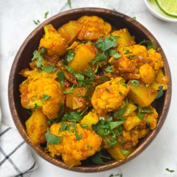 aloo gobi served in a bowl garnished with coriander leaves