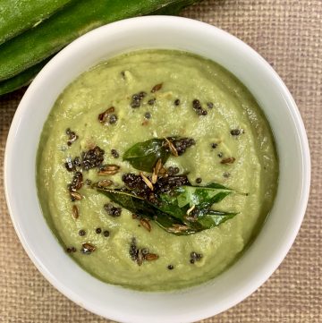 ridge gourd chutney served in a bowl topped with tempering