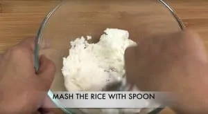 step to mash the cooked rice in the bowl