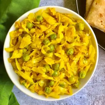 Cabbage Peas Stir Fry served in a bowl with chapati on the side