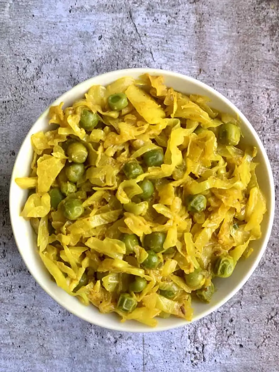cabbage peas stir fry served in a white bowl