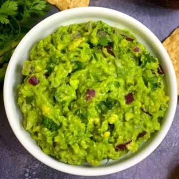 Chipotle copycat avocado guacamole served in a bowl with tortilla chips on the side